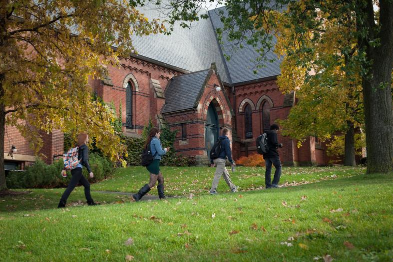 Students walking past the exterior of Sage Chapel.