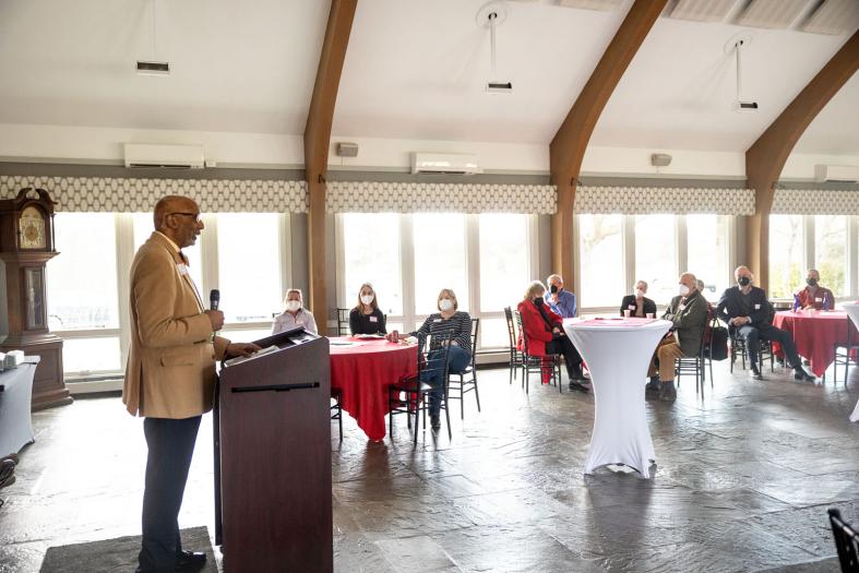 Speaker with small gathering at Moakley House
