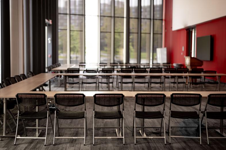 Seating configuration with tables and chairs in a 'U' shape.