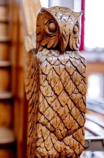 Willard Straight Hall Memorial Room features ornate woodworking details such as this owl banister.