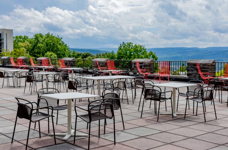 Outdoor chairs and tables on the Willard Straight Hall Terrace 