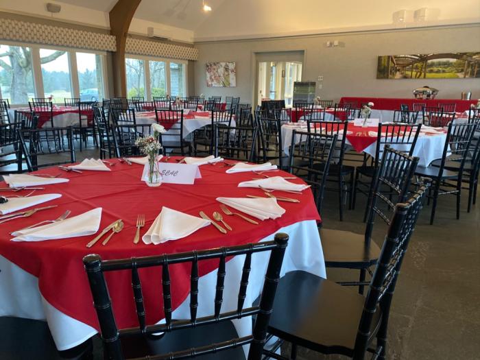 Moakley House set up with chairs, tables, and linens for an event.