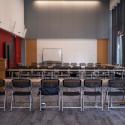 Seating configuration with tables and chairs in a 'U' shape.