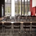 Seating configuration with tables and chairs in a 'U' shape.