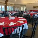 Moakley House set up with chairs, tables, and linens for an event.