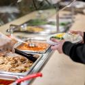 Cornell Dining staff serving at a buffet line.